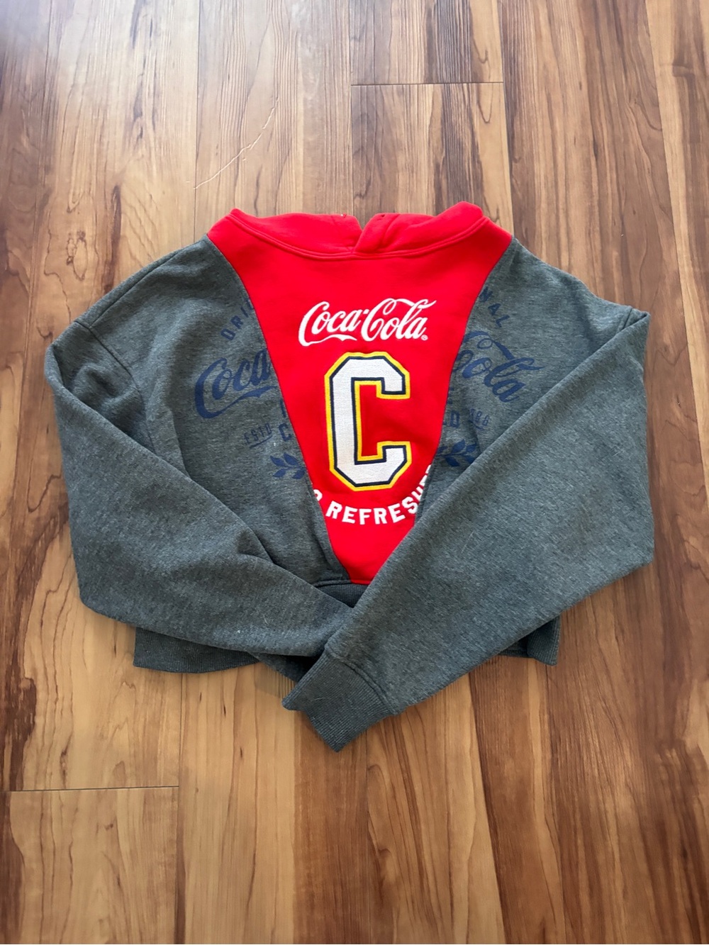 NWOT. Coca-Cola Red Hooded Sweatshirt with Yellow & Navy Patch